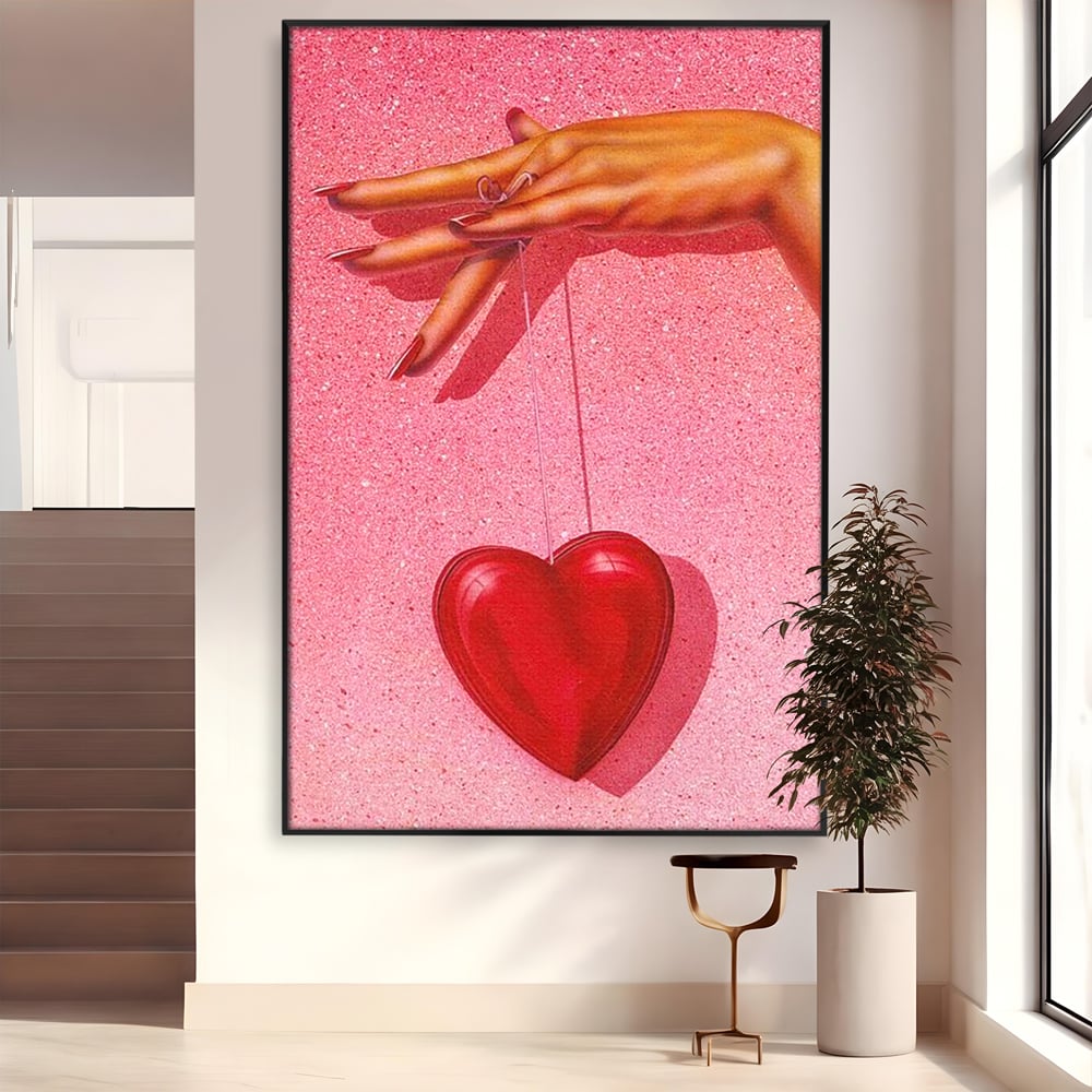 Tablou canvas cu ilustratie cu mana care tine o inima rosie, in rama de aluminiu negru